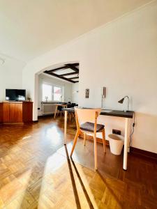 a living room with a table and a chair at 3 sonnige Appartements in Soltau in Soltau