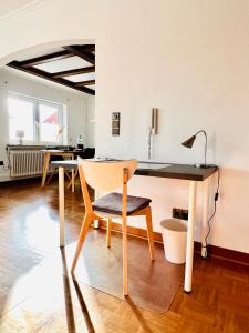 a dining room with a desk and a chair at 3 sonnige Appartements in Soltau in Soltau +55 photos