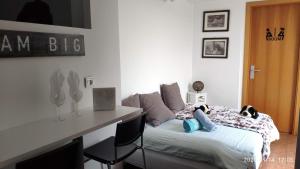 a bedroom with a bed and a desk in it at loft con terraza y barbacoa in Lumpiaque
