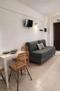a living room with a couch and a table at Filoxenia in Platy