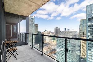 a balcony with a view of a city at Luxury Apartments with View & Indoor Heated Pool in Montreal