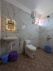 a bathroom with a sink and a toilet and a sink at Shree's Seaside Homestay - Sea Pearl in Magdāl