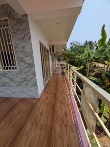 a hallway of a house with wooden floors and plants at Shree's Seaside Homestay - Sea Pearl in Magdāl