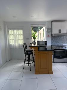 a kitchen with a counter and chairs in it at Moulin A vent apartment in Monchy