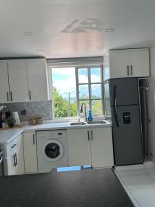 a kitchen with a refrigerator and a sink and a dishwasher at Moulin A vent apartment in Monchy