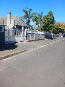 a white picket fence in front of a house at 1krom str bellville boston in Bellville