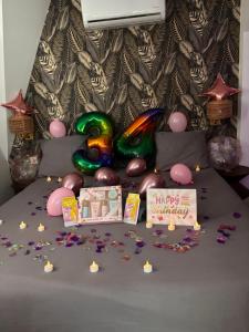 a table with a bunch of chocolates and a happy birthday cake at Hôtel Particulier Cour Dupont - Résidence en Autonomie in Montargis