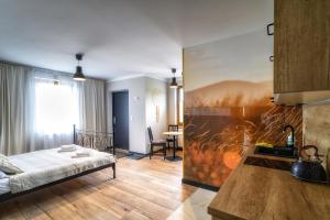 a room with a bed and a table in it at Przystanek Babia Apartamenty in Lipnica Wielka +31 photos