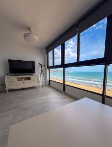 a living room with a view of the ocean at Espacio I in Cullera