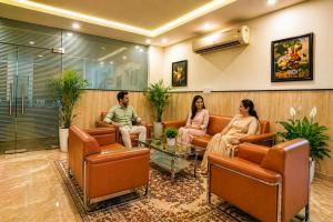 a group of people sitting in a waiting room at Hotel Kian by JMD Group in New Delhi