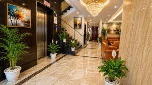 a lobby with potted plants in a building at Hotel Kian by JMD Group in New Delhi +9 photos