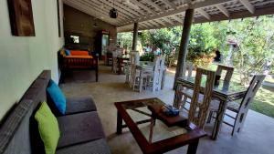 a living room with a couch and tables and chairs at Villa Ali in Galle