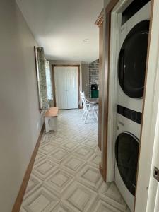 a hallway with a washer and dryer in a house at Restored 1800s Farmhouse on Working Sheep Farm in Bird-in-Hand