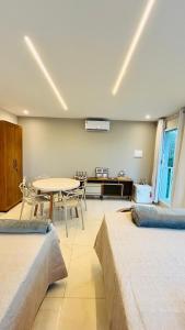 a room with a table and chairs and a dining room at Blessed House Atins in Atins +1 photo