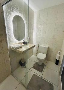 a bathroom with a toilet and a mirror at Blessed House Atins in Atins