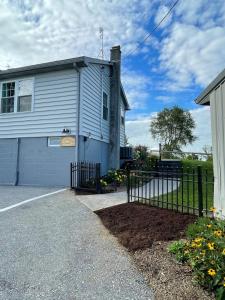 a house with a fence in front of it at Restored 1800s Farmhouse on Working Sheep Farm in Bird-in-Hand