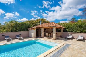 a villa with a swimming pool and a gazebo at Lux pool Villa Zen - located in peaceful village near Rijeka and Opatija in Klana