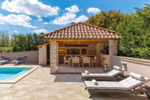 a backyard with a pool and a gazebo at Lux pool Villa Zen - located in peaceful village near Rijeka and Opatija in Klana