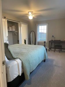 a bedroom with a bed and a ceiling fan at Restored 1800s Farmhouse on Working Sheep Farm in Bird-in-Hand