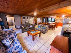 a living room with two couches and a table at Reefteach Lodge in Sodwana Bay