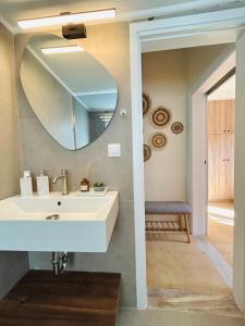 a bathroom with a sink and a mirror at Grandpa’s cottage in Nea Makri +25 photos