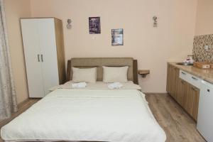 a bedroom with a large bed with towels on it at Apartments Valentinaa in Gevgelija