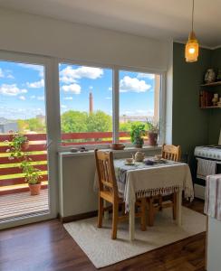 a dining room with a table and chairs and a balcony at PAE korter Kärdlas in Kärdla