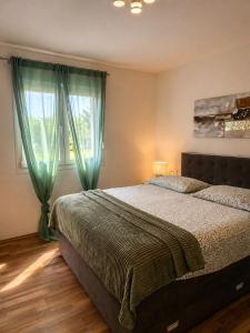 a bedroom with a bed and a window with green curtains at Villa Heaven Green in Pazin +51 photos
