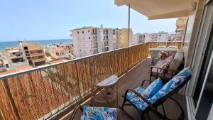 a balcony with two chairs and a view of the ocean at Vista al Mar in Piles