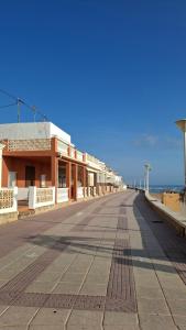 an empty street in front of a building at Vista al Mar in Piles +36 photos