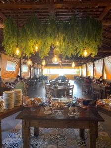 a dining room with a table with plates of food at Lonier Nature INN in Abraão +48 photos