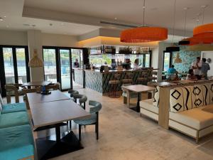 a restaurant with tables and chairs and a bar at VIP AL FATTAh LUXURY in Estepona