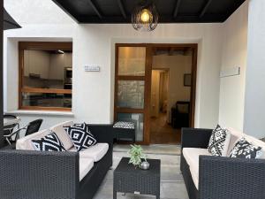 a patio with couches and tables and a dining room at Apartamentos Miguel 2 in Onís