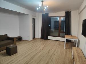 a living room with a couch and a table at Voievozilor Residence in Constanţa