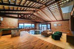 a large living room with a brick wall at Luxury Oceanfront House - Beachfront - Pool in Aquiraz