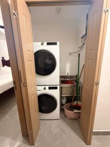 a washer and dryer in a small room at Royal's 2 Bedroom suite in Kingston