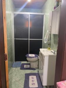 a small bathroom with a toilet and a sink at Sítio Meu Cantinho in Benedito Novo