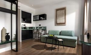 a living room with a couch and a table at Zea Urban Living in Piraeus