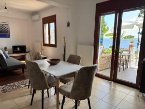 a living room with a white table and chairs at HillSide Apartments - 02 in Agia Galini