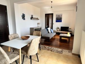 a living room with a table and a couch at HillSide Apartments - 02 in Agia Galini