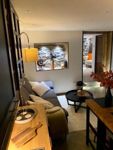 a living room with a couch and a table at l atelier in Bozel