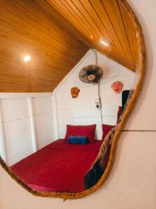 a bedroom with a red bed in a small room at Ayaan Beach Home in Dodanduwa