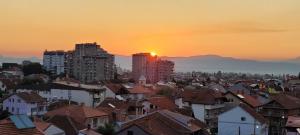 a view of a city with buildings and the sunset at Lina Apartment in Bitola