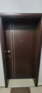 a sliding glass door with a brown door at Lina Apartment in Bitola
