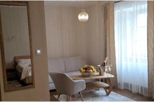 a living room with a table with a bowl of fruit on it at Penzión Jánsky kaštieľ Bohumírovský in Liptovský Ján