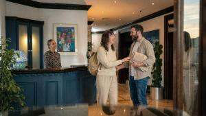a man and a woman standing in a room at Schull Harbour Hotel & Leisure Centre in Schull
