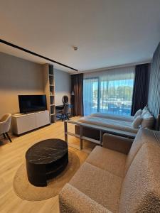 a living room with a bed and a couch at Baltic Infinity in Międzyzdroje