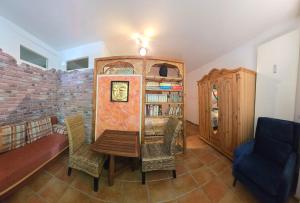a living room with a table and a book shelf at Surya Villa Holistic Stay Prenzlauer Berg in Berlin