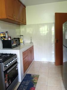 a small kitchen with a stove and a refrigerator at Classy bedroom Ngong in Ngong
