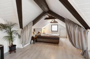 a bedroom with a bed in a attic at Schwarzwaldglück Loft in St. Blasien